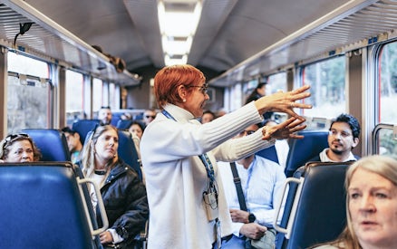 Tour guide speaking to passengers on the Bernina Red Train, St. Moritz.