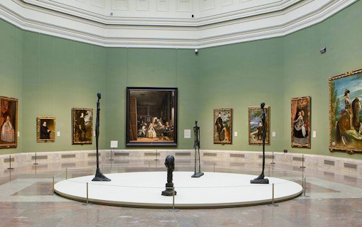 Prado Museum gallery with paintings and sculptures on display.