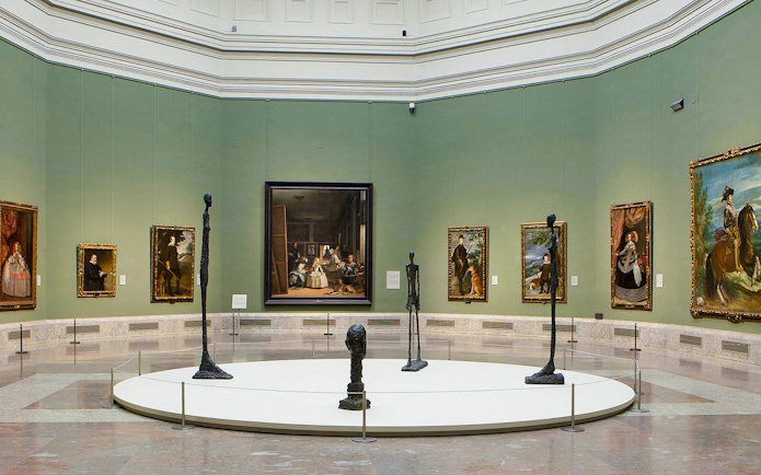 Prado Museum gallery with paintings and sculptures on display.