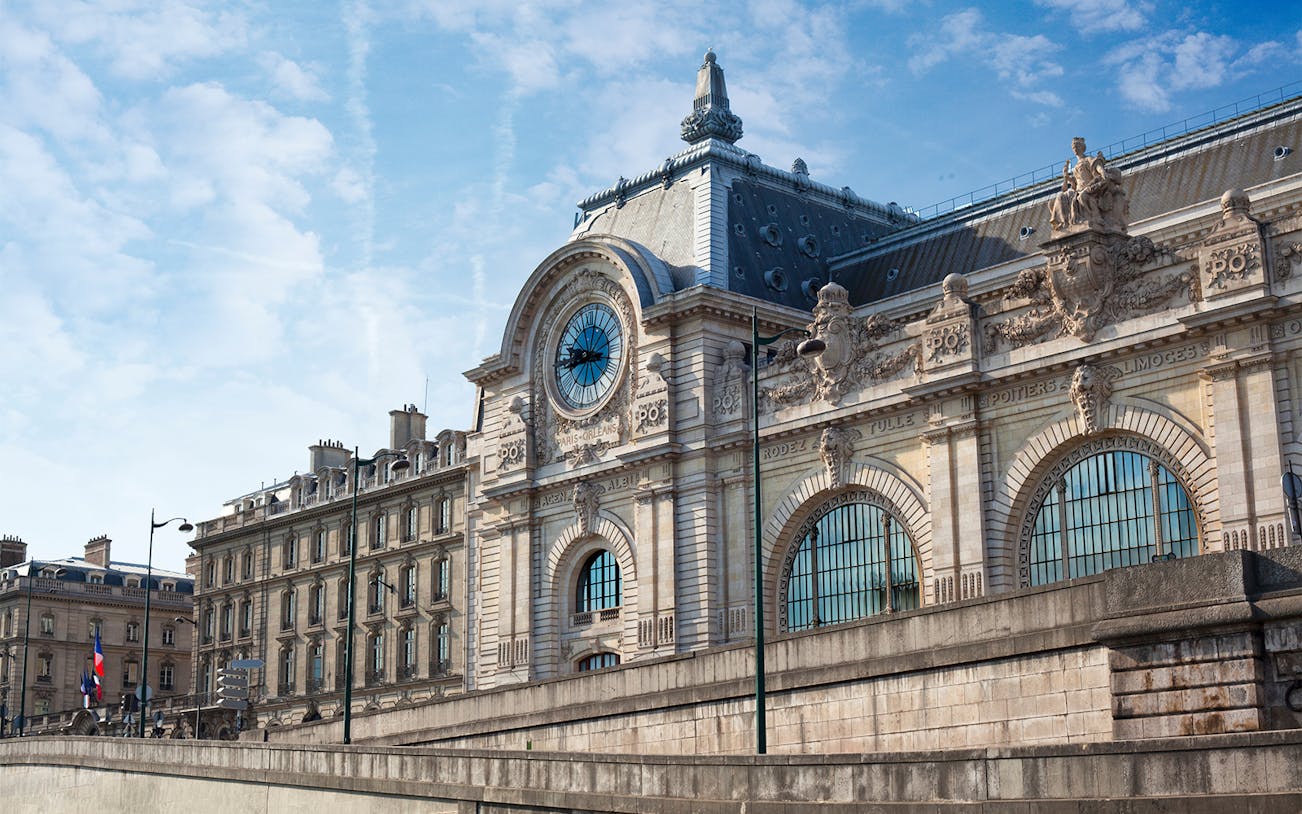 Orsay Museum facade with clock and ornate sculptures in Paris, France.