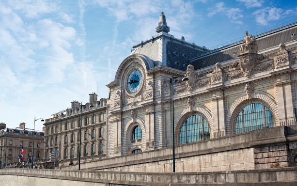 Orsay Museum facade with clock and ornate sculptures in Paris, France.