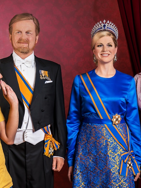 Visitors posing with wax figures at Madame Tussauds Amsterdam.