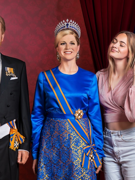 Visitors posing with wax figures at Madame Tussauds Amsterdam.