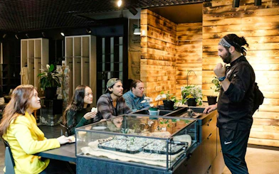 Tour guide explaining coffee varieties to a group during a VIP morning market experience.