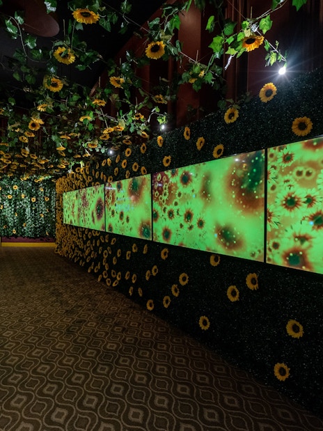 Van Gogh sunflower-themed hallway at Arte Museum exhibition.