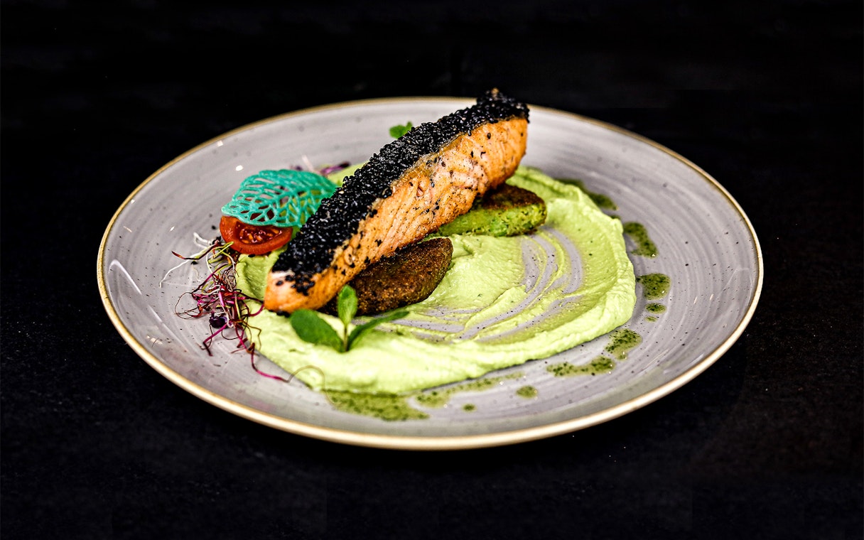 Grilled salmon with black sesame on pea puree, served on a Christmas cruise in Budapest.