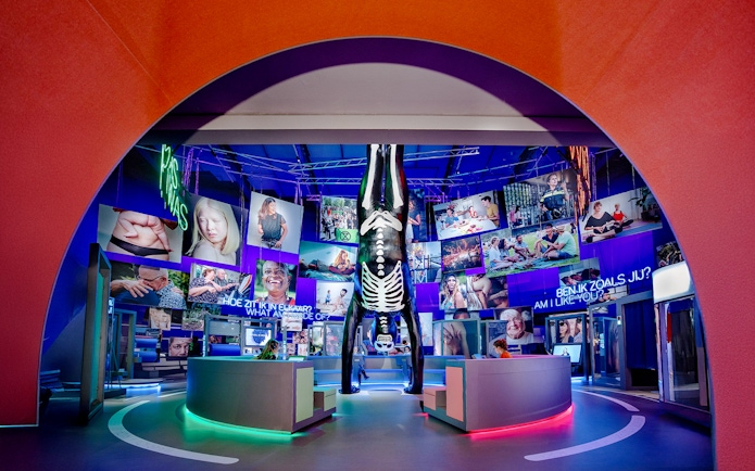 Visitors engaging with human biology exhibit, interacting with models and digital screens.