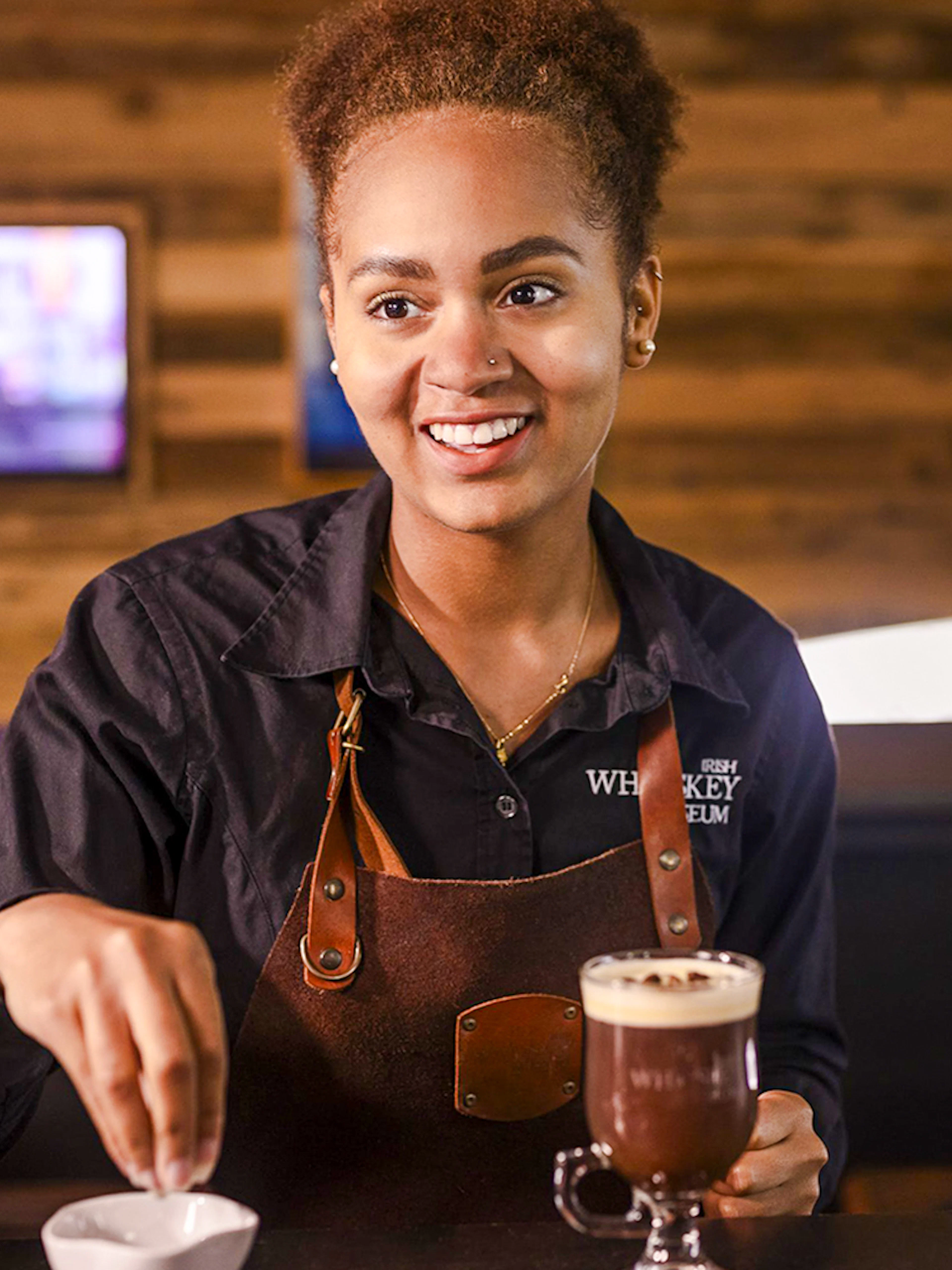 Barista preparing Irish coffee at the Irish Whiskey Museum masterclass.