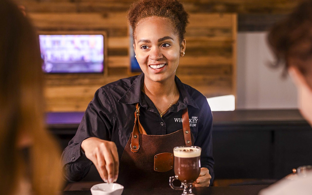 Barista preparing Irish coffee at the Irish Whiskey Museum masterclass.
