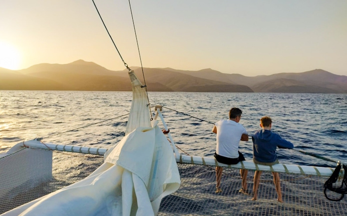 Tourists on a cruise boat at sunset in Lanzarote, watching for whales and dolphins.