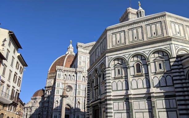 Florence's Duomo Square with Cathedral and Baptistery under clear sky.