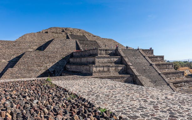People climbing the Pyramid of the Moon in Teotihuacan, Mexico.
