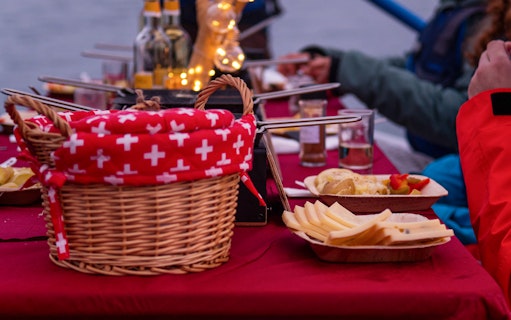 River rafting tour in Interlaken with raclette dinner setup on a table.