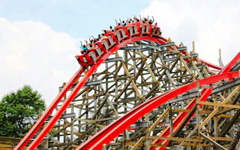 Medusa Steel Coaster at Six Flags Mexico with riders on a red track loop.