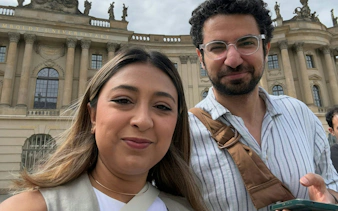 Two people in front of Humboldt University, Berlin, during a self-guided city exploration game.