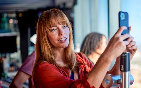 Person taking a photo at Melbourne Skydeck, Eureka Tower.