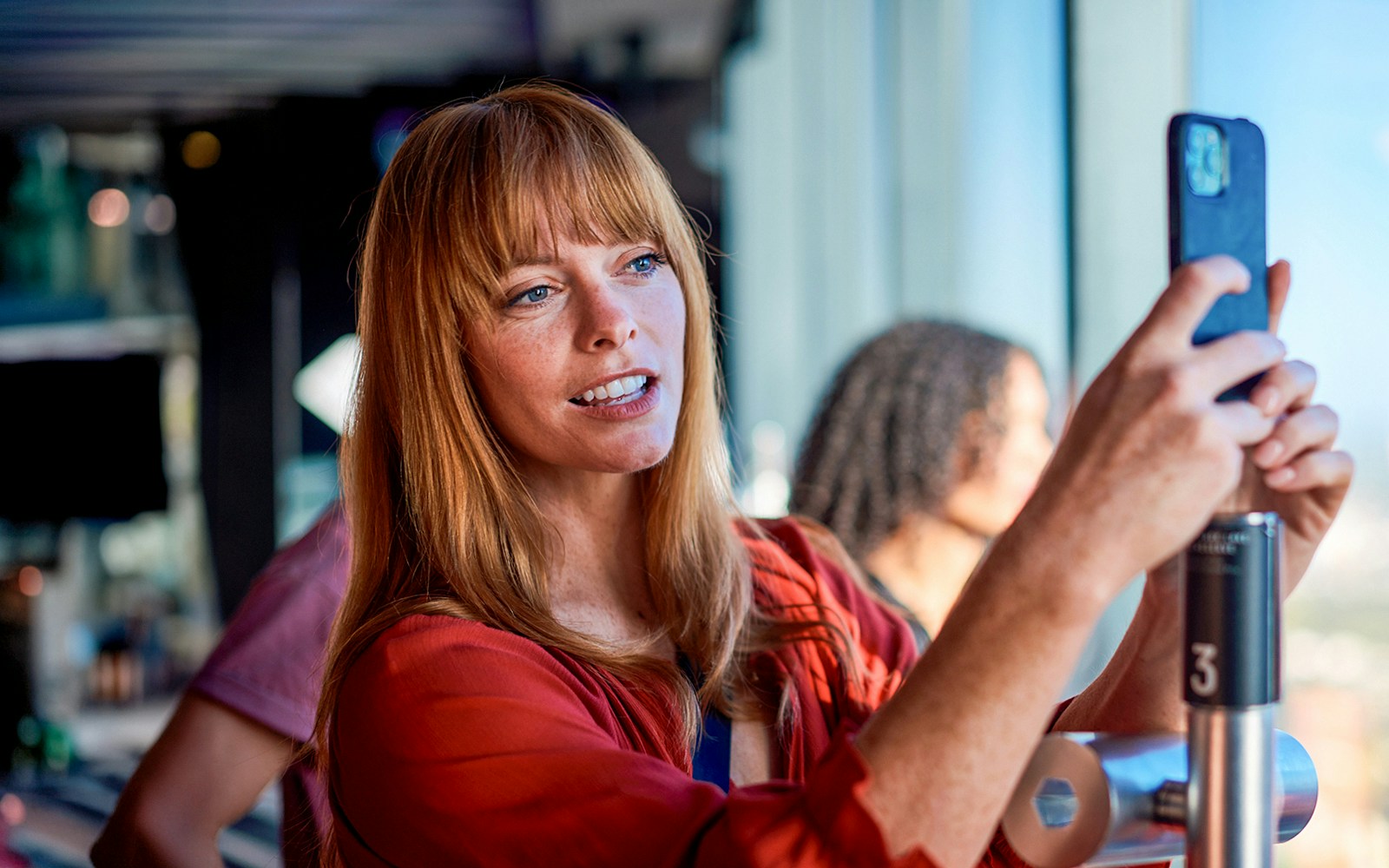 Person taking a photo at Melbourne Skydeck, Eureka Tower.