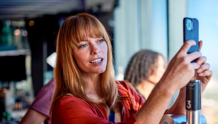 Person taking a photo at Melbourne Skydeck, Eureka Tower.