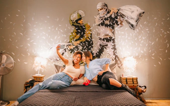Visitors taking a selfie in front of Banksy artwork at Banksy Museum Barcelona.