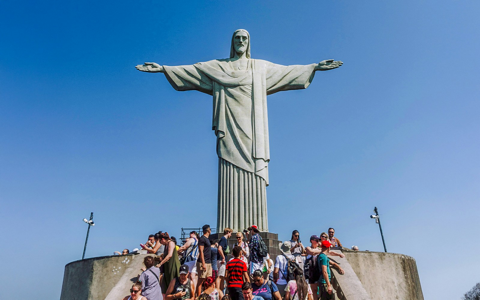 Crowd gathered at the base of Christ the Redeemer statue in Rio de Janeiro, Brazil.