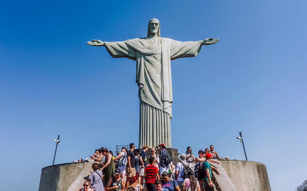 Crowd gathered at the base of Christ the Redeemer statue in Rio de Janeiro, Brazil.