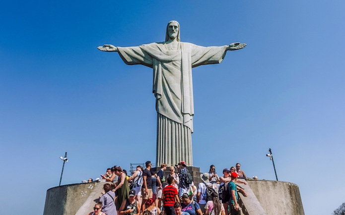 Crowd gathered at the base of Christ the Redeemer statue in Rio de Janeiro, Brazil.