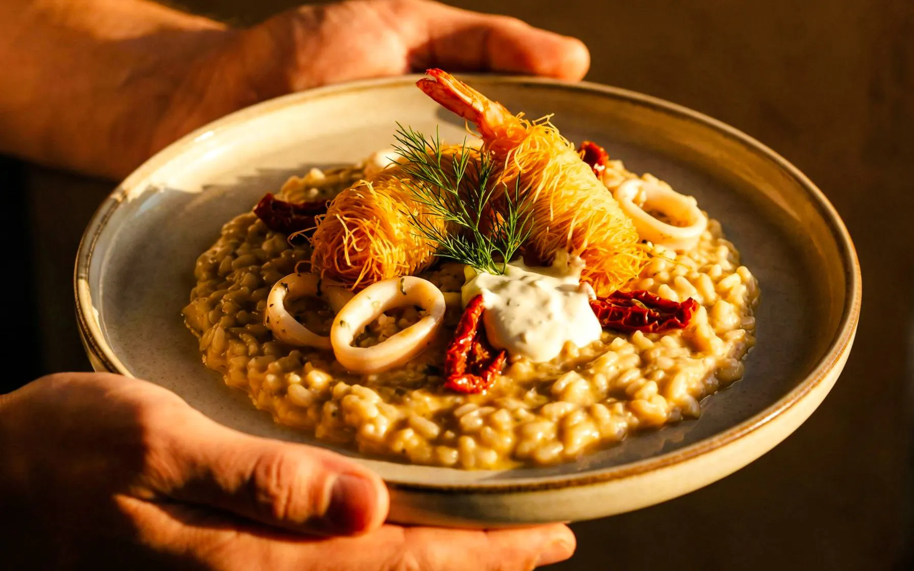 Seafood risotto with shrimp and calamari served on Heraklion catamaran cruise.