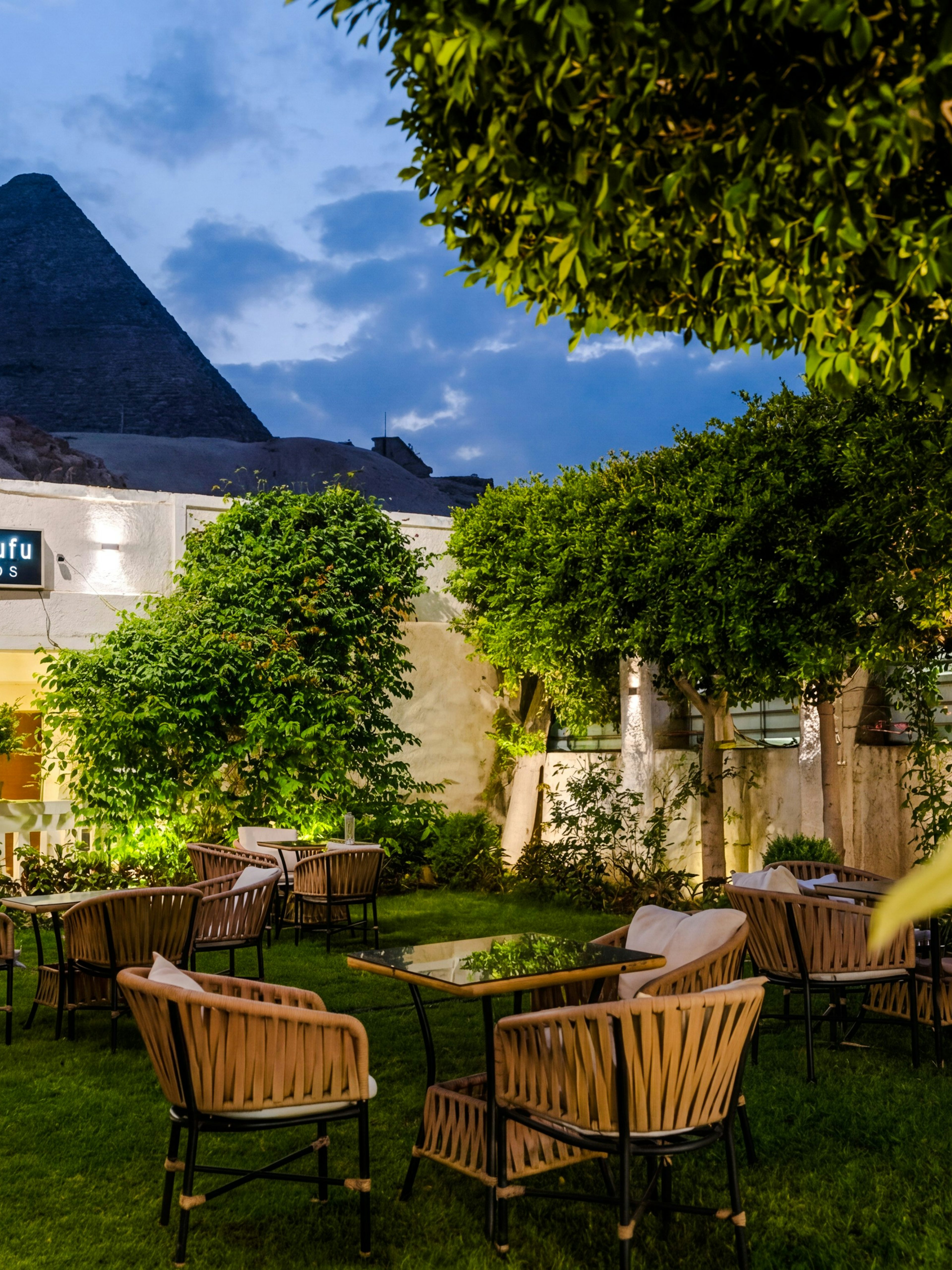 Dinner setting at Villa Khufu with view of the Great Pyramid in Giza, Egypt.