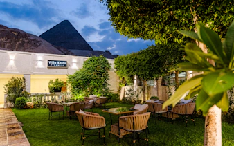 Dinner setting at Villa Khufu with view of the Great Pyramid in Giza, Egypt.