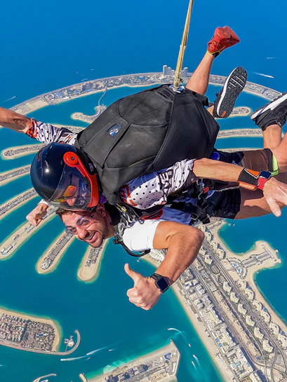 Skydivers tandem jumping over Palm Jumeirah, Dubai.