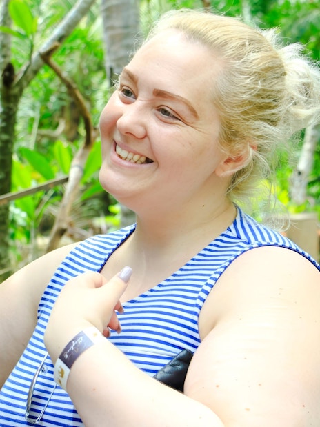 Tourist interacting with a parrot at Lombok Wildlife Park.