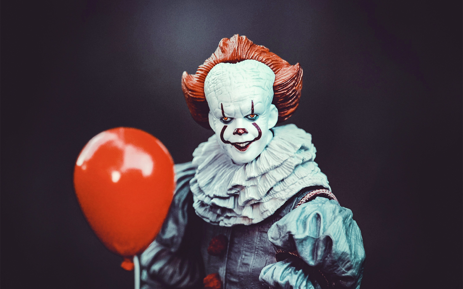 Wax figure of IT clown holding a red balloon at Madame Tussauds, NYC.
