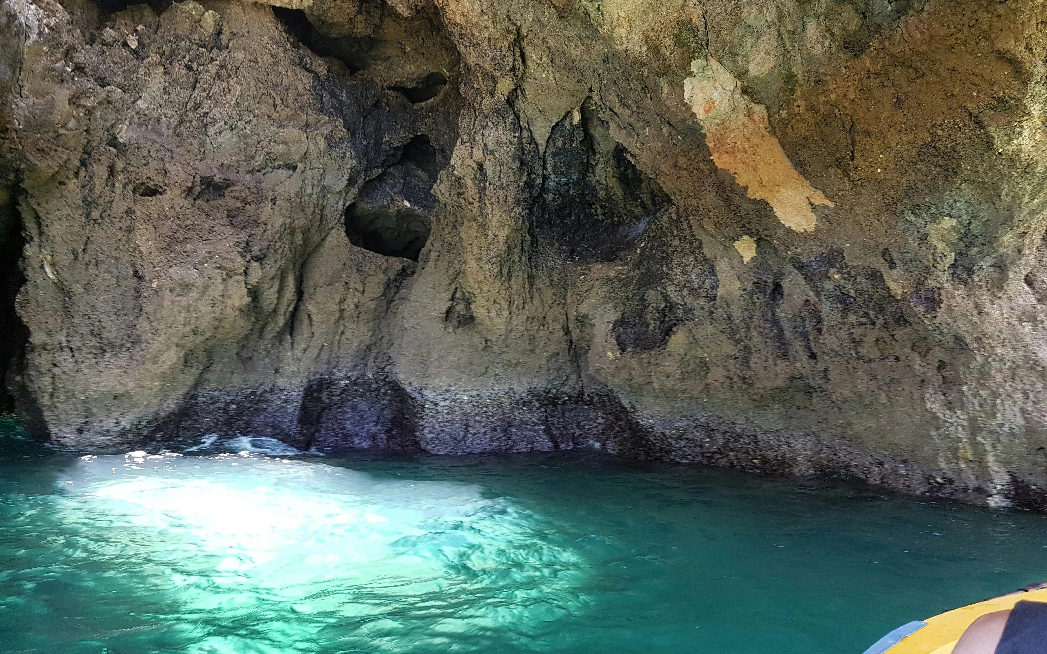 Rocky cave formations with turquoise water on Ponta da Piedade boat tour from Lagos.