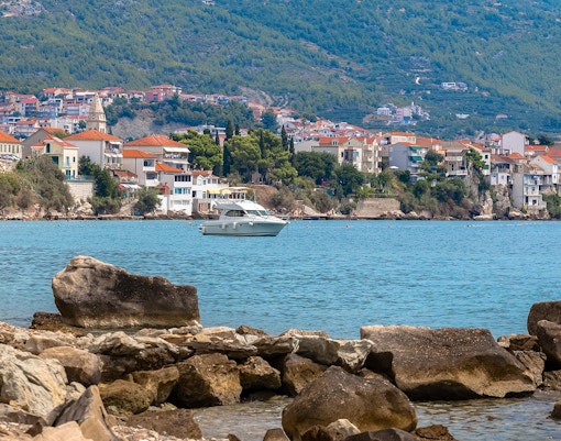 Kayaking in the Adriatic Sea near Podstrana with coastal town view.