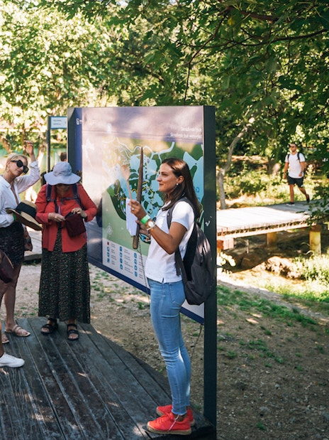 Tour group listening to a guide at Krka National Park during a Split wine tasting trip.