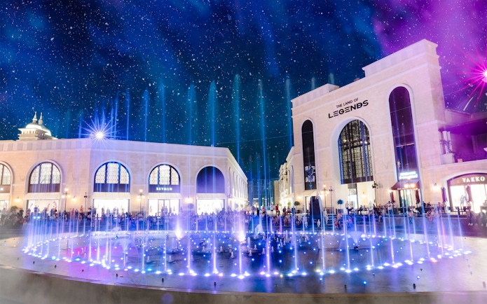 Water fountain illuminated at night, The Land of Legends theme park.