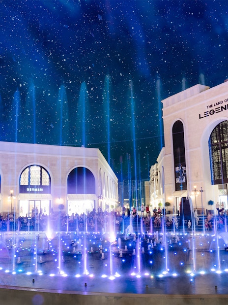 Water fountain illuminated at night, The Land of Legends theme park.