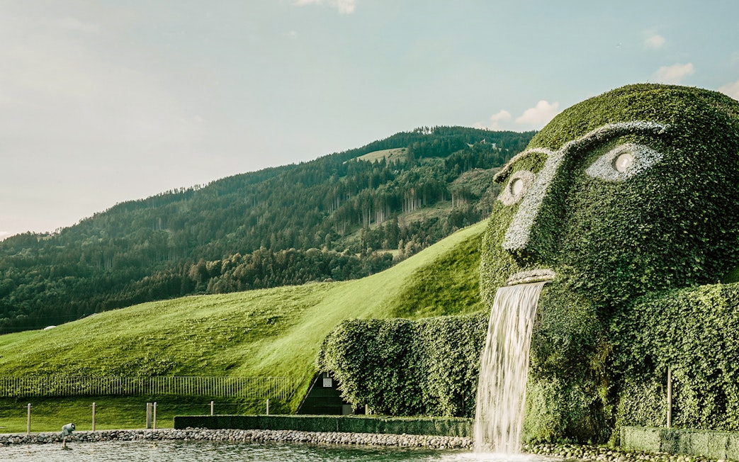 Giant hedge sculpture with waterfall in The Garden of the Giant, Austria.