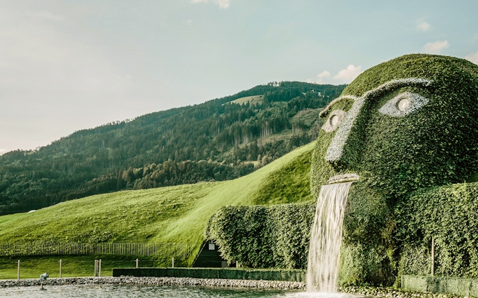 Giant hedge sculpture with waterfall in The Garden of the Giant, Austria.