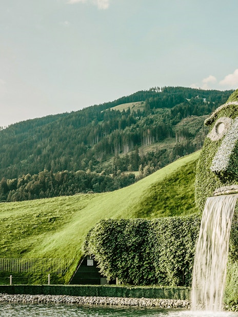 Giant hedge sculpture with waterfall in The Garden of the Giant, Austria.