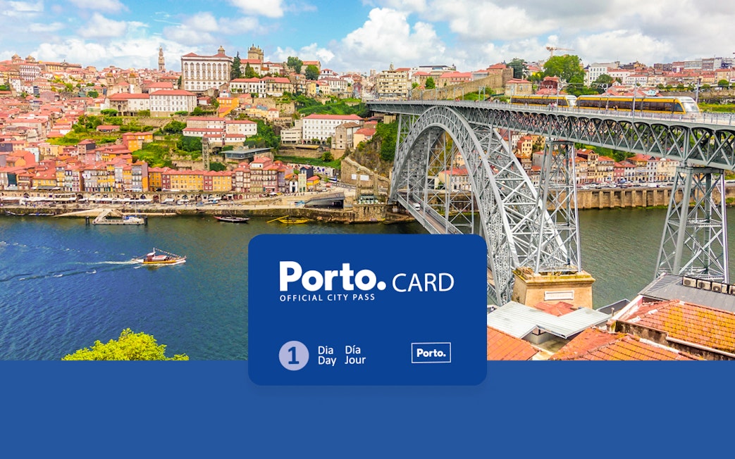View of Porto's old town with the cathedral, Ponte de Dom Luis I, and colorful buildings along the Duoro River.