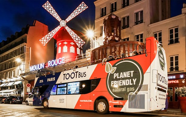 Tootbus in front of Moulin Rouge at night, Paris hop-on-hop-off tour.