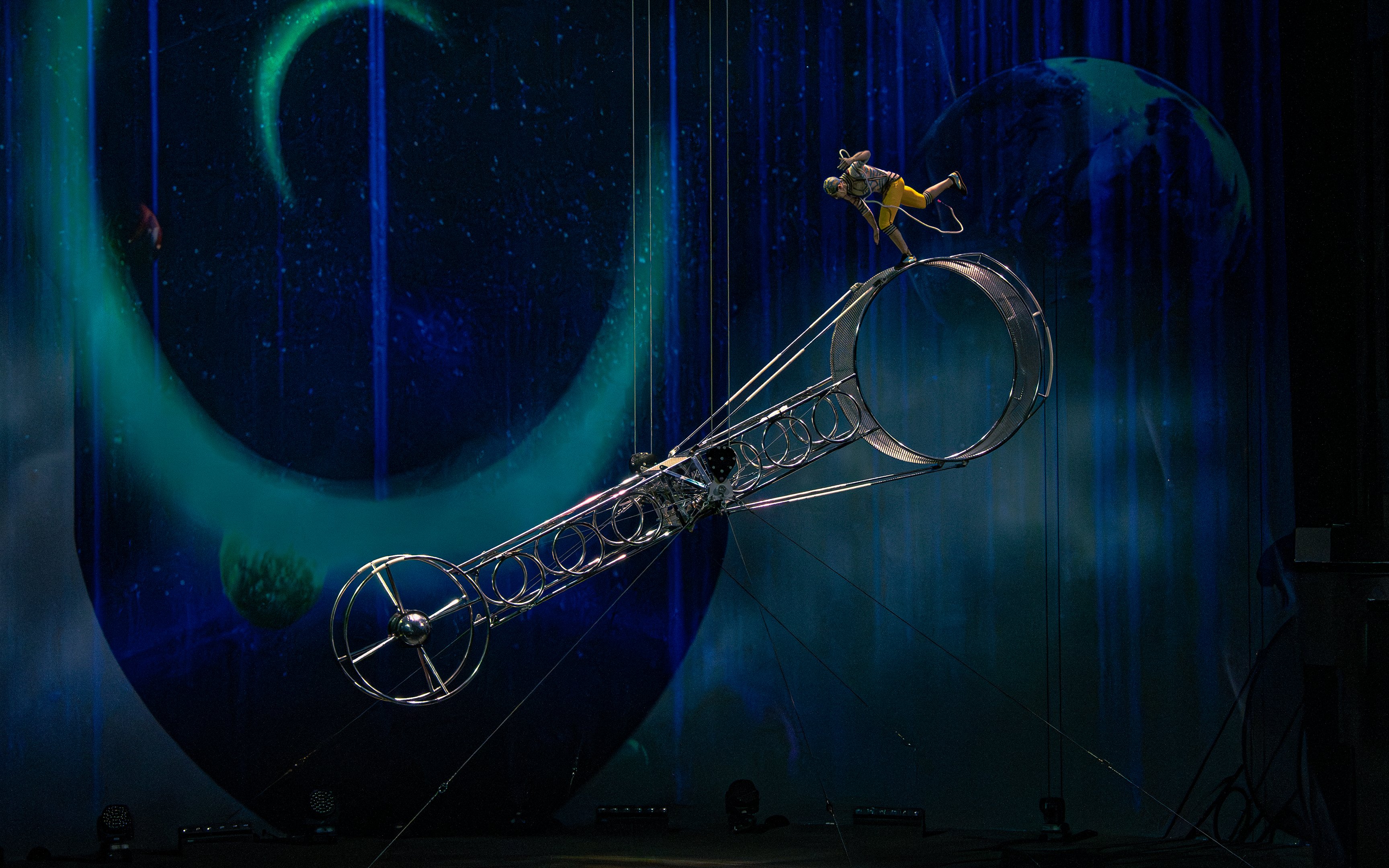 Performer balancing on a rotating wheel at La Perle show, Dubai.