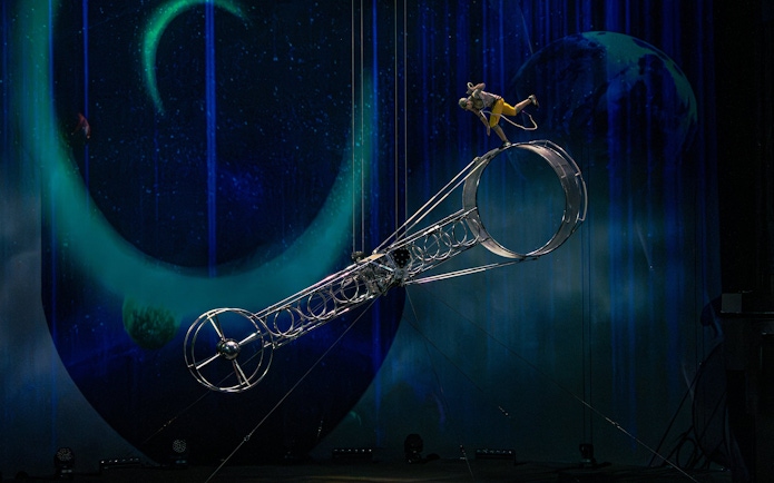 Performer balancing on a rotating wheel at La Perle show, Dubai.