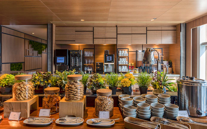 Buffet setup with snacks and beverages at Plaza Premium Lounge.