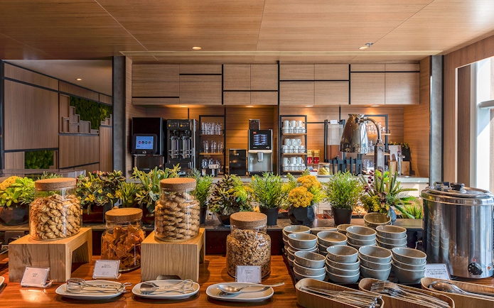 Buffet setup with snacks and beverages at Plaza Premium Lounge.