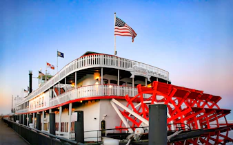 Steamboat Natchez docked in New Orleans, ready for dinner cruise boarding.