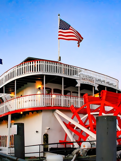 Steamboat Natchez docked in New Orleans, ready for dinner cruise boarding.
