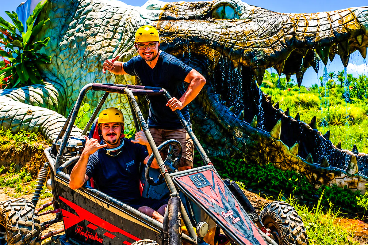 Buggy riders in front of a giant crocodile sculpture on the Ubud Bali adventure tour.