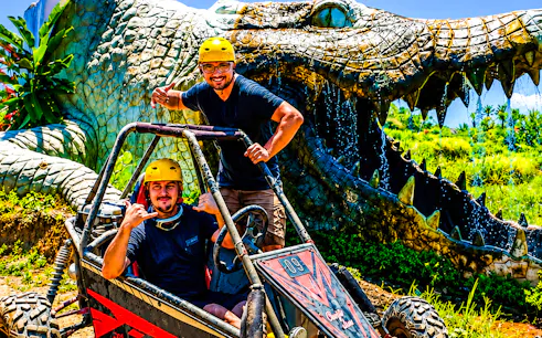 Buggy riders in front of a giant crocodile sculpture on the Ubud Bali adventure tour.